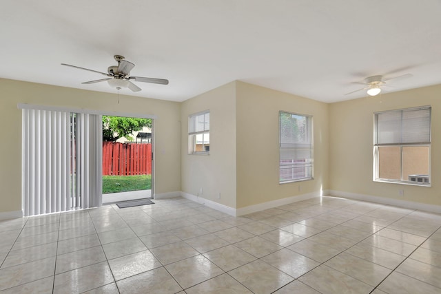 tiled spare room featuring ceiling fan