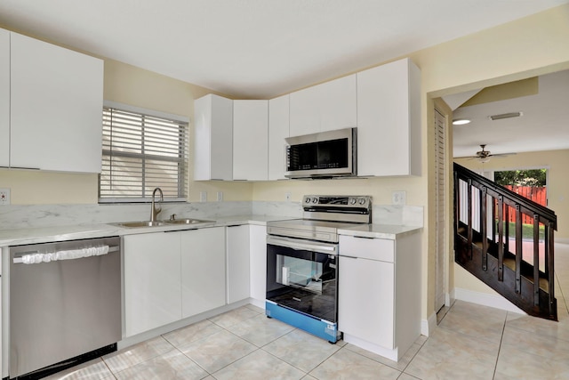 kitchen with ceiling fan, sink, white cabinets, and appliances with stainless steel finishes