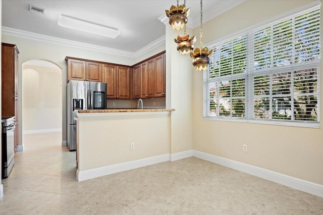 kitchen with crown molding, hanging light fixtures, a textured ceiling, and appliances with stainless steel finishes