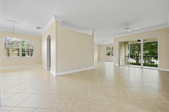 tiled empty room with ceiling fan with notable chandelier, plenty of natural light, and ornamental molding