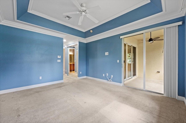 spare room featuring ceiling fan, a raised ceiling, and crown molding