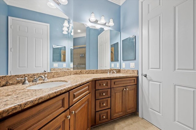 bathroom with vanity, a shower with shower door, and ornamental molding