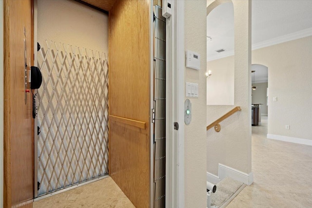 interior details featuring ornamental molding and elevator