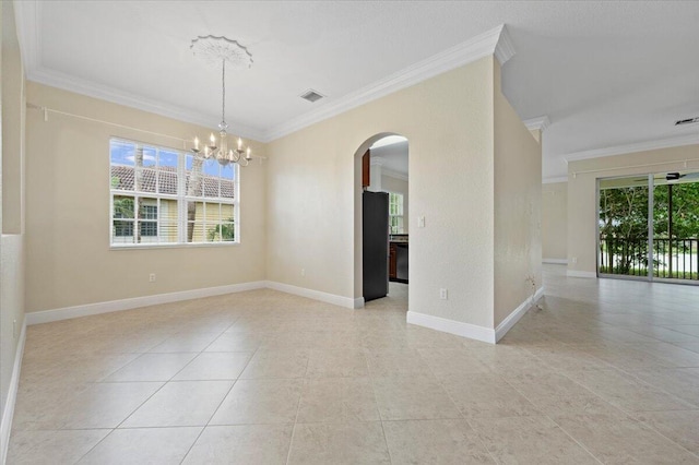 unfurnished room featuring crown molding and a notable chandelier