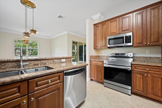 kitchen with dark stone countertops, sink, ornamental molding, and stainless steel appliances