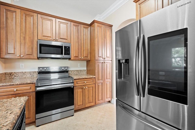 kitchen featuring light stone counters, ornamental molding, and stainless steel appliances