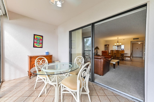 dining space featuring a chandelier and light tile patterned floors