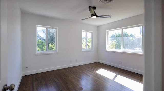 empty room with ceiling fan and dark hardwood / wood-style flooring