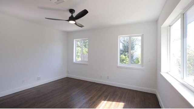 unfurnished room with dark hardwood / wood-style flooring, plenty of natural light, and ceiling fan