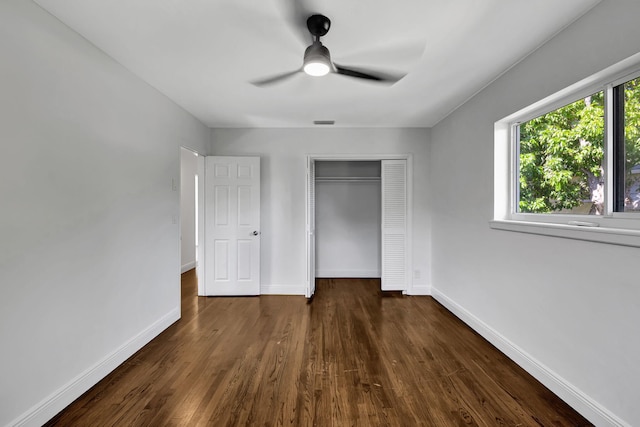 unfurnished bedroom featuring ceiling fan, a closet, and dark hardwood / wood-style floors