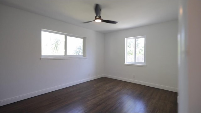 unfurnished room with ceiling fan and dark hardwood / wood-style floors