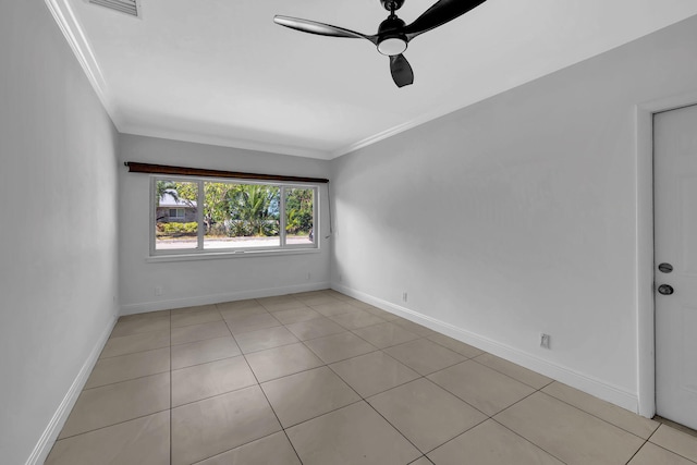 tiled spare room featuring ceiling fan and crown molding