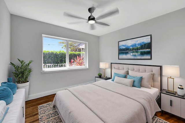 bedroom with dark hardwood / wood-style flooring and ceiling fan