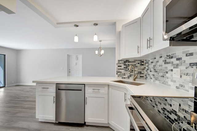 kitchen featuring white cabinets, stainless steel appliances, and light wood-type flooring