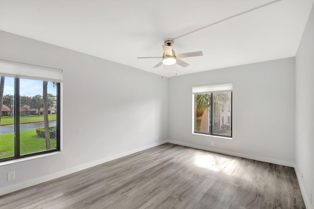 empty room with light wood-type flooring and ceiling fan