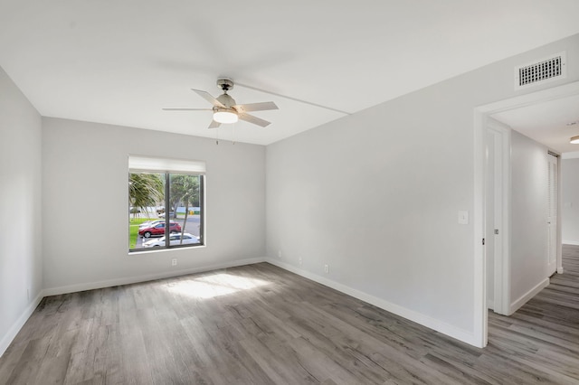 spare room featuring ceiling fan and hardwood / wood-style floors