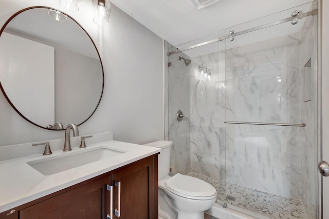 bathroom with vanity, toilet, and an enclosed shower