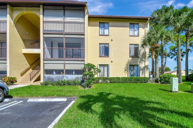811 Sky Pine Way Unit D2, Greenacres, FL 33415 - view of building exterior featuring uncovered parking