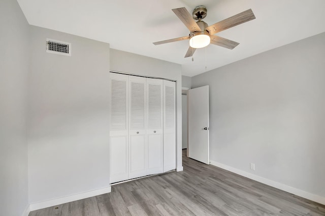 811 Sky Pine Way Unit D2, Greenacres, FL 33415 - unfurnished bedroom featuring wood finished floors, baseboards, a closet, and a ceiling fan