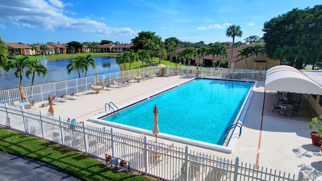 view of pool with a patio and a water view