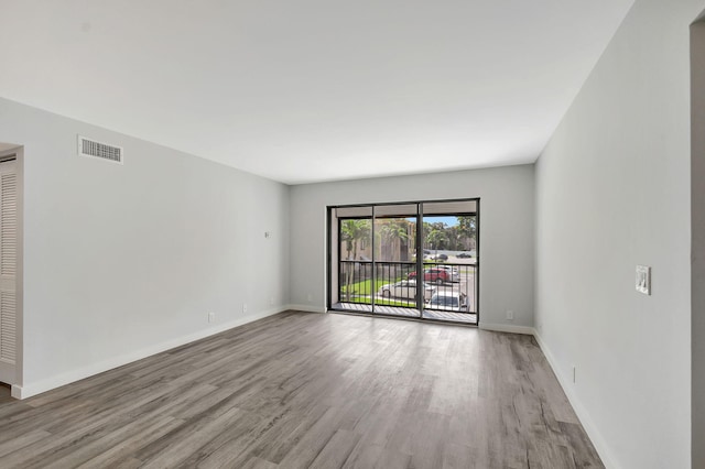 spare room featuring light hardwood / wood-style floors