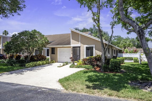 ranch-style home featuring a front lawn and a garage