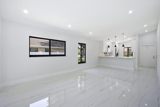 unfurnished living room featuring lofted ceiling