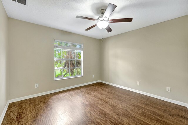 spare room with hardwood / wood-style floors, ceiling fan, and a textured ceiling