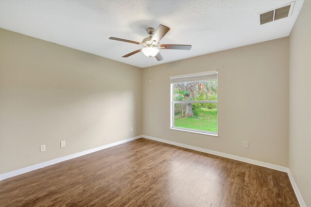 unfurnished room featuring hardwood / wood-style floors, ceiling fan, and a textured ceiling