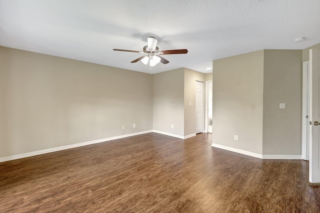 empty room featuring dark wood-type flooring, a textured ceiling, and ceiling fan