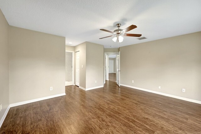 unfurnished room featuring dark wood-type flooring, a textured ceiling, and ceiling fan