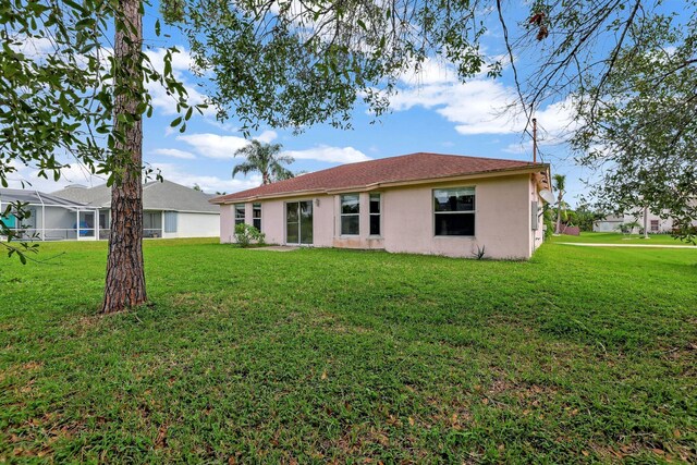 rear view of house with a yard