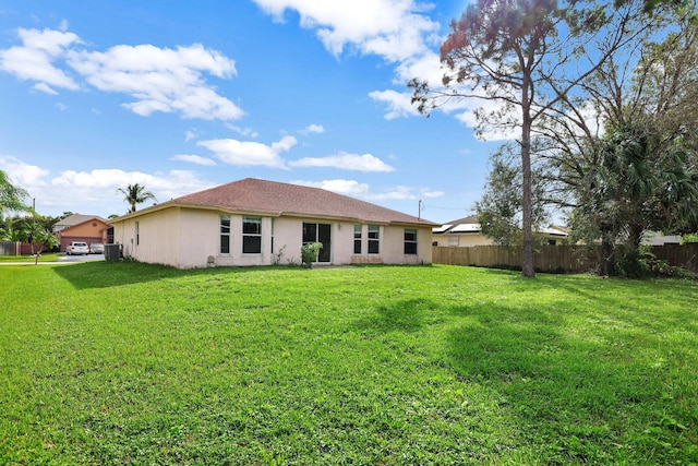 rear view of property with a yard