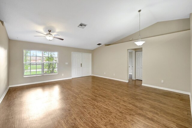 unfurnished room with dark wood-type flooring, ceiling fan, and vaulted ceiling