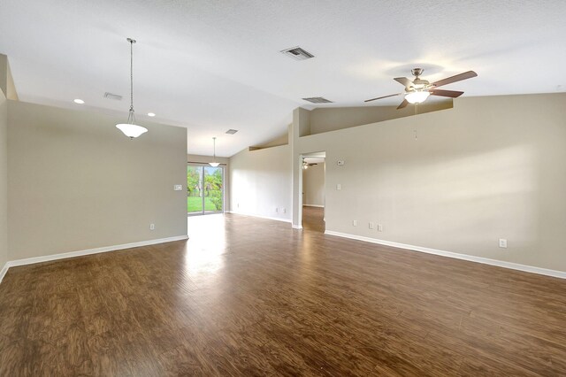 spare room with lofted ceiling, ceiling fan, and dark wood-type flooring