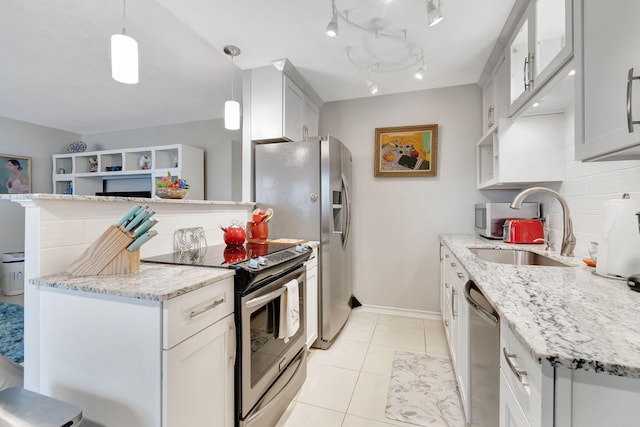 kitchen featuring white cabinetry, light stone countertops, appliances with stainless steel finishes, and hanging light fixtures