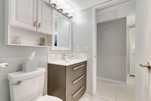 bathroom with vanity, toilet, and tile patterned floors