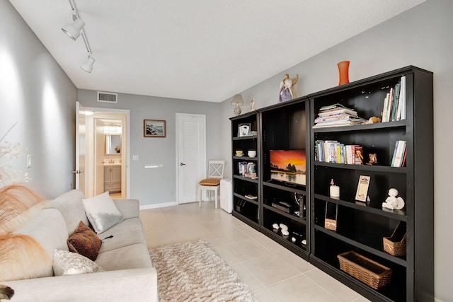 living room featuring track lighting and light tile patterned floors