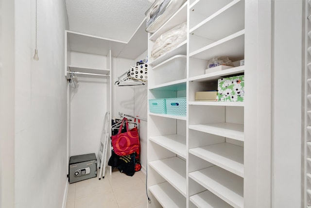 walk in closet featuring light tile patterned floors