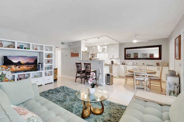 tiled living room featuring ceiling fan