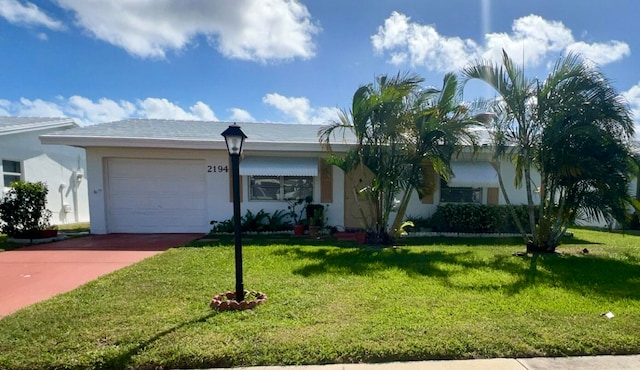 ranch-style home featuring a garage and a front lawn