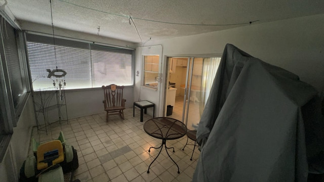 miscellaneous room featuring light tile patterned flooring and a textured ceiling