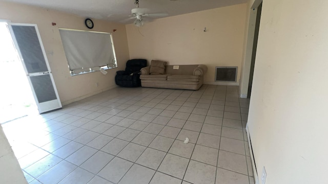 unfurnished living room with light tile patterned floors and ceiling fan