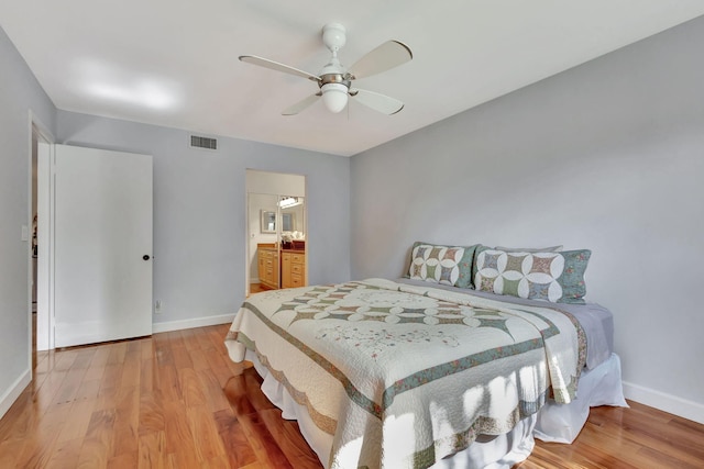 bedroom with wood-type flooring, connected bathroom, and ceiling fan