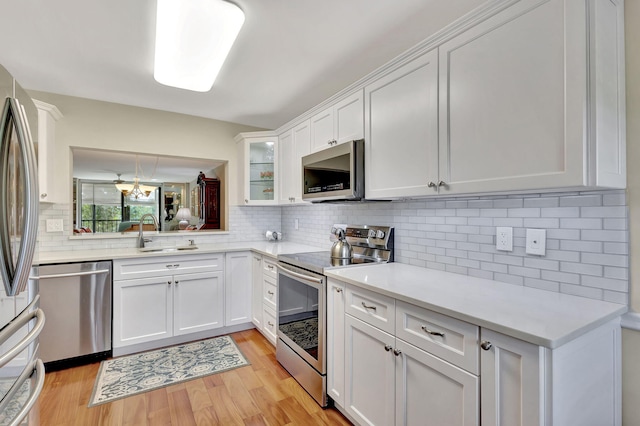 kitchen featuring white cabinets, appliances with stainless steel finishes, and sink