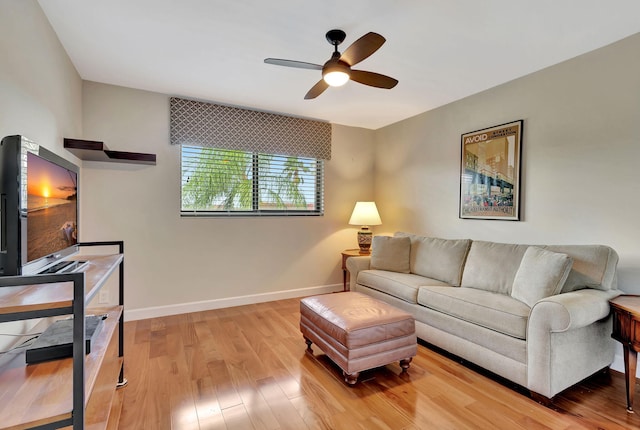 living room with ceiling fan and light hardwood / wood-style floors