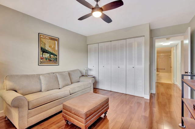 living room with ceiling fan and wood-type flooring