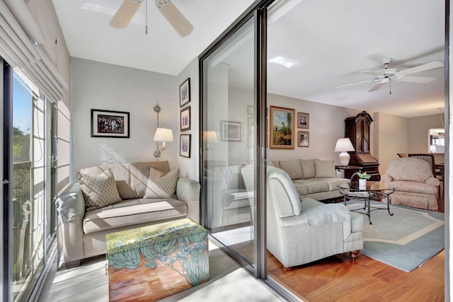 living room featuring light hardwood / wood-style flooring and ceiling fan