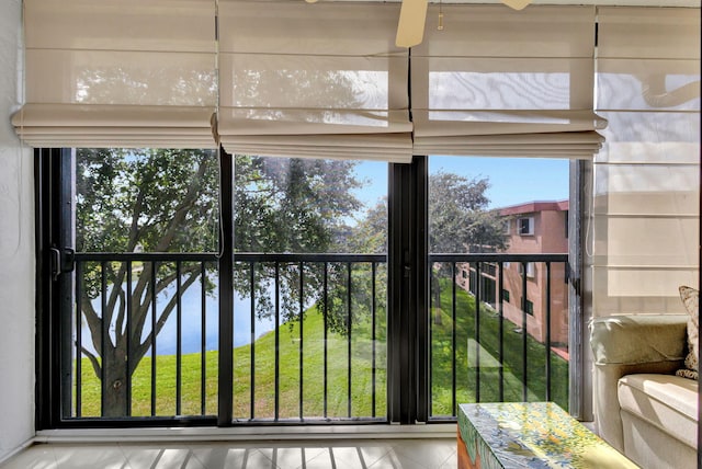 sunroom / solarium featuring a water view