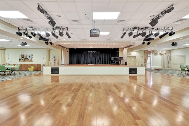 misc room featuring hardwood / wood-style floors and a drop ceiling